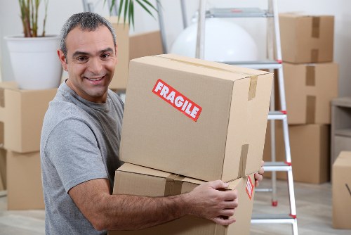 Team preparing a safe man and van move with equipment
