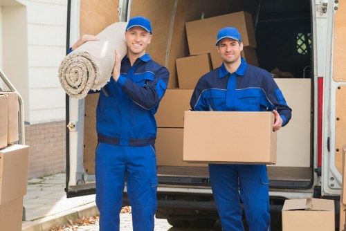 Staff using safe lifting techniques with furniture