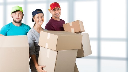 Office movers transporting desks and equipment in North London