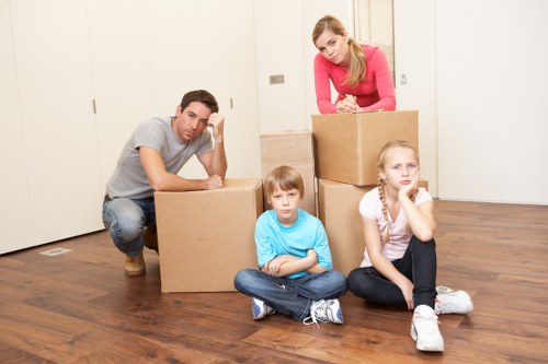 Packed office boxes and furniture ready for relocation in Hornsey